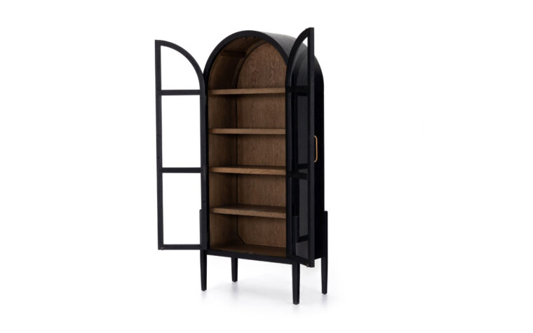 A black arched bookcase by Four Hands with both doors open to reveal drifted oak interiors.