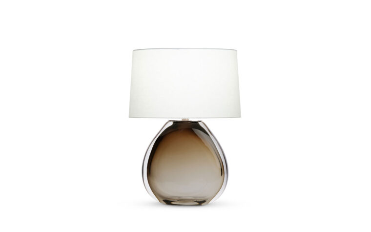 Oriole glass table lamp by Flow Decor with light on.