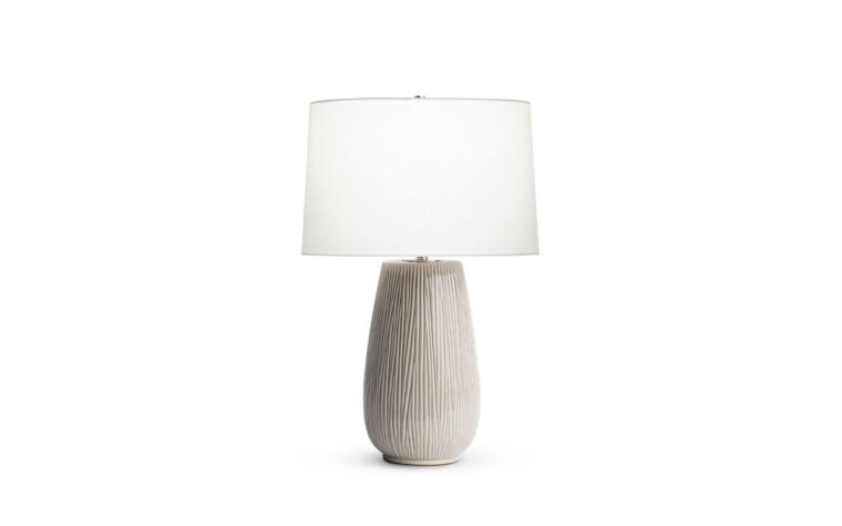 Hilda textured ceramic table lamp by Flow Decor with light on.