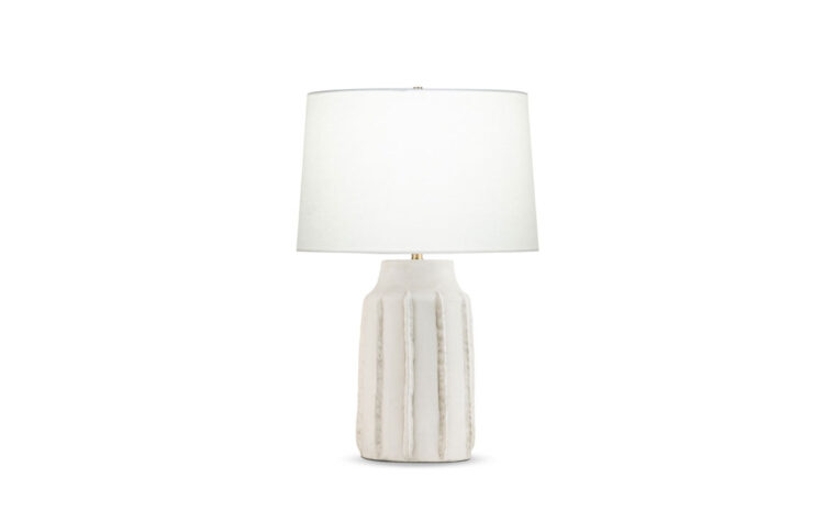 Valentina ribbed ceramic lamp by Flow Decor with light on.