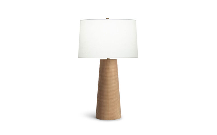 Sanibel wood table lamp by Flow Decor with light on.