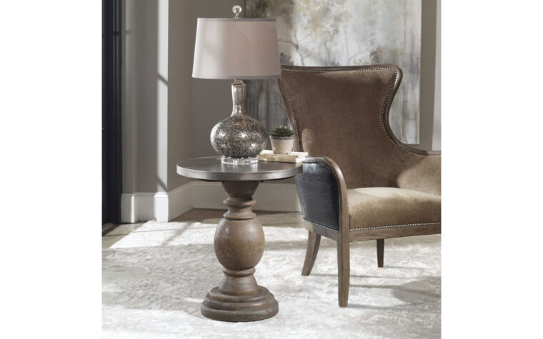 The Blythe pedestal side table made from solid wood by Uttermost styled next to antique chair.