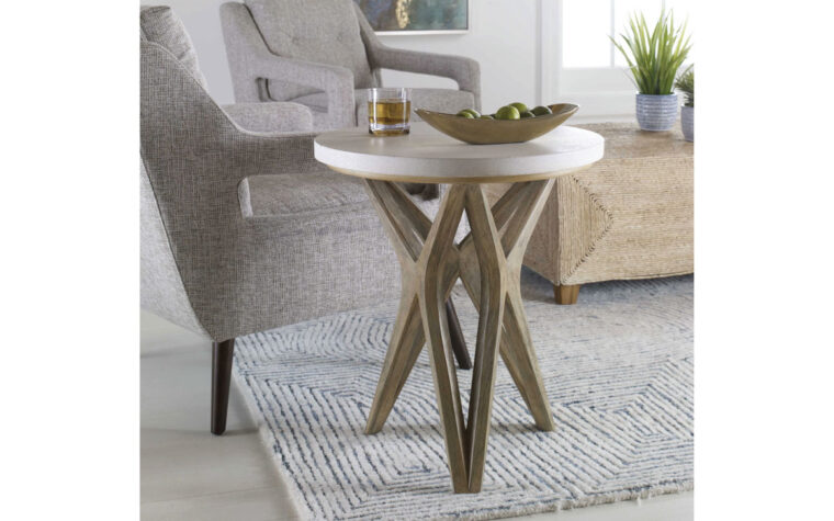 The Marnie handcrafted wood side table placed beside grey seat.