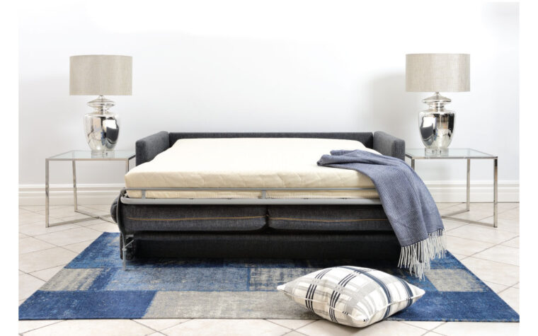 Blue sofa bed couch in its folded out position.