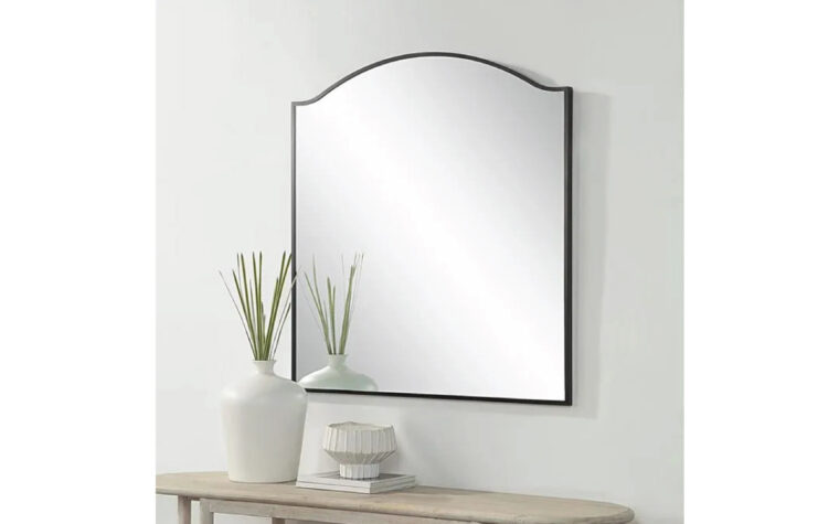 Rectangular arched mirror hanging on wall