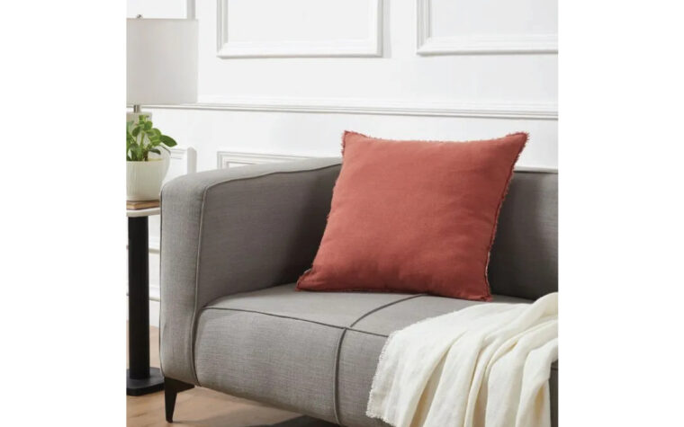 Terracotta throw pillow by Renwil styled on grey couch