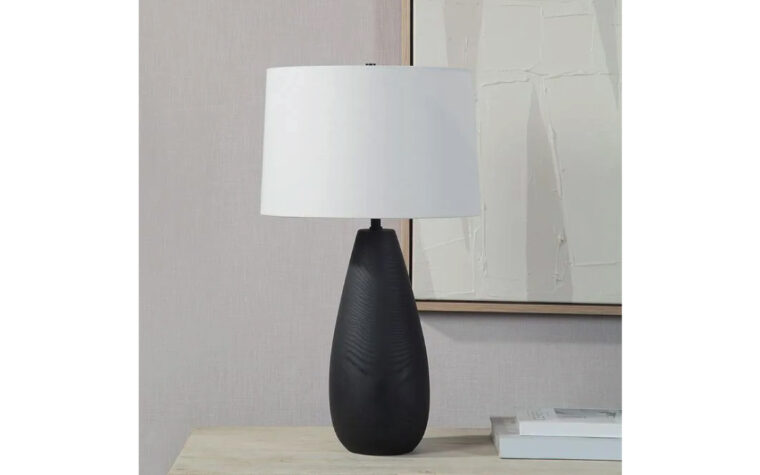 The tala table lamp sitting on a credenza