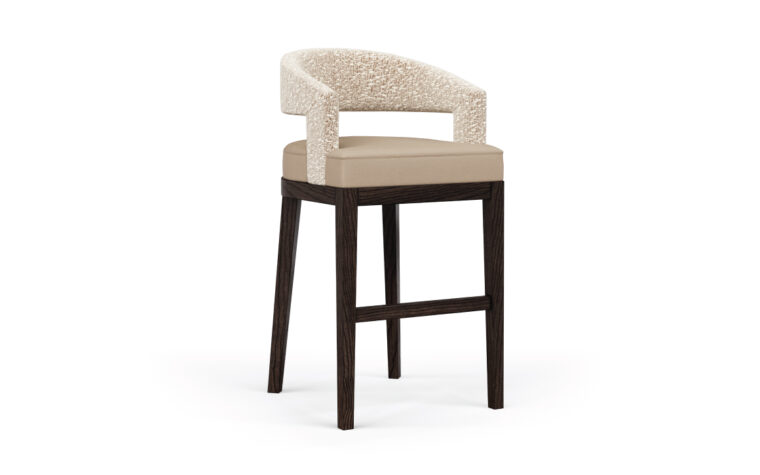The Zayn bar stool with a fabric seat and wooden legs.