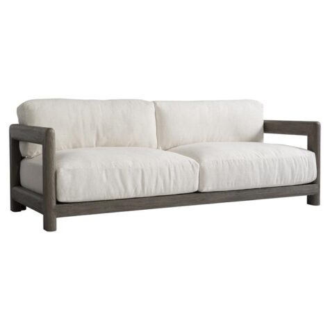front view of the montaigne outdoor sofa in a weathered grey finish with white cushions with showwood arms and back