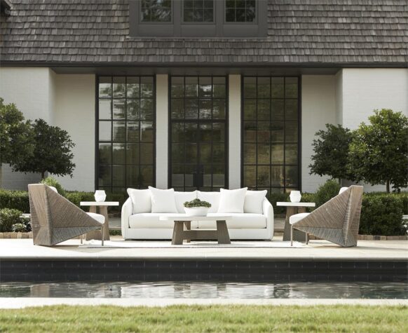an outdoor photo in a luxury house backyard by the pool of the solana sofa in white by bernhardt