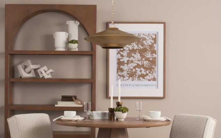 a beautiful gold pendant above a dining table