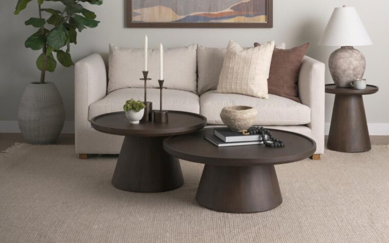 two nesting wooden cocktail tables in a living room with a sofa