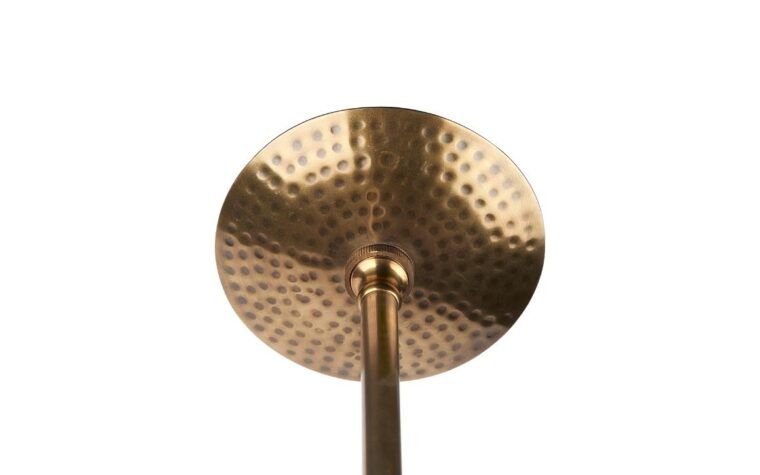 a detail shot of gold hammered ceiling plate for the pendant