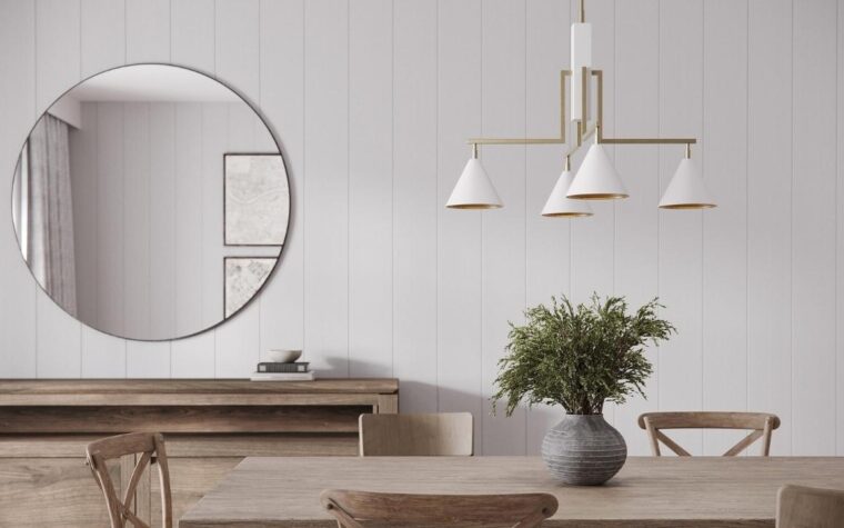 a dining room in white with a rustic dining table with a chandelier with white lamp shades on it