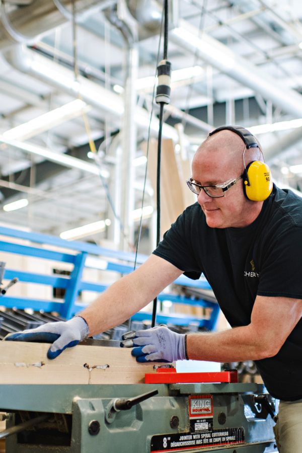 a man manufacturing wood in a shop