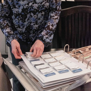 designer flipping through blind material selection