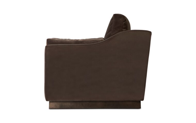 the side view of the plinith club chair in a dark brown velvet with dark brown stained base by theodore alexander