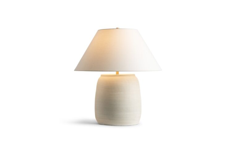 the regina table lamp by flow decor with the light shown on